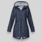 Navy blue women’s insulated parka with striped hood lining and double front zips.