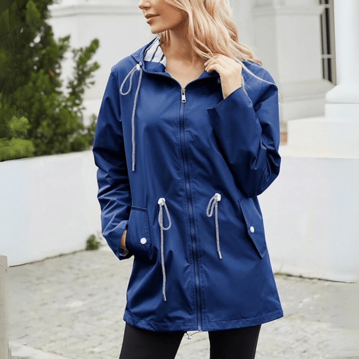 Navy blue women’s hooded jacket with full zipper and adjustable waist drawstrings.