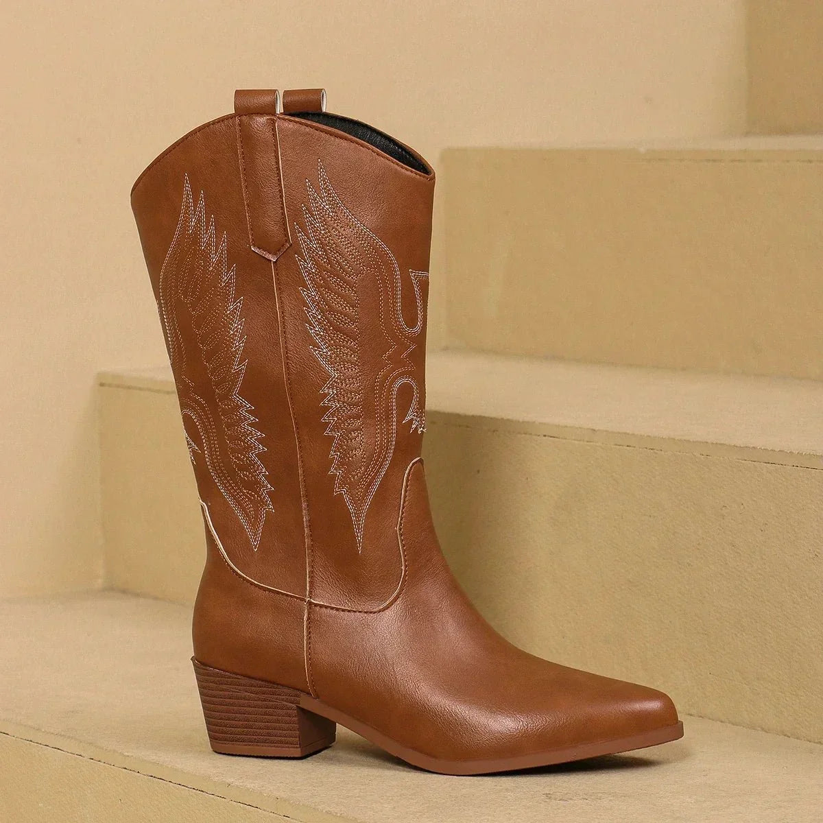 Women’s embroidered pointed-toe cowgirl boots in brown with block heel and leaf-style embroidery.