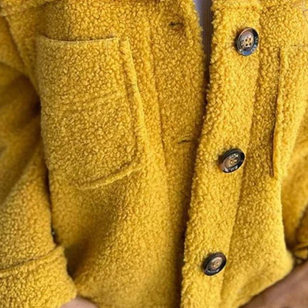 Close-up of yellow button-front sherpa cardigan with two flap chest pockets