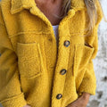 Yellow collared sherpa cardigan with button placket and two chest flap pockets