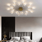 Gold LED flush mount ceiling lamp with radial slim rods and bright illuminated bulbs