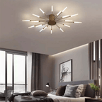 Gold LED flush mount ceiling lamp with radial rod arms and glowing light bulbs