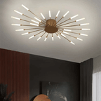 Gold LED flush mount ceiling lamp with radial rod arms and glowing bulbs on ceiling