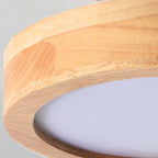 Wood flush mount ceiling lamp close-up showing light edge and acrylic diffuser curve