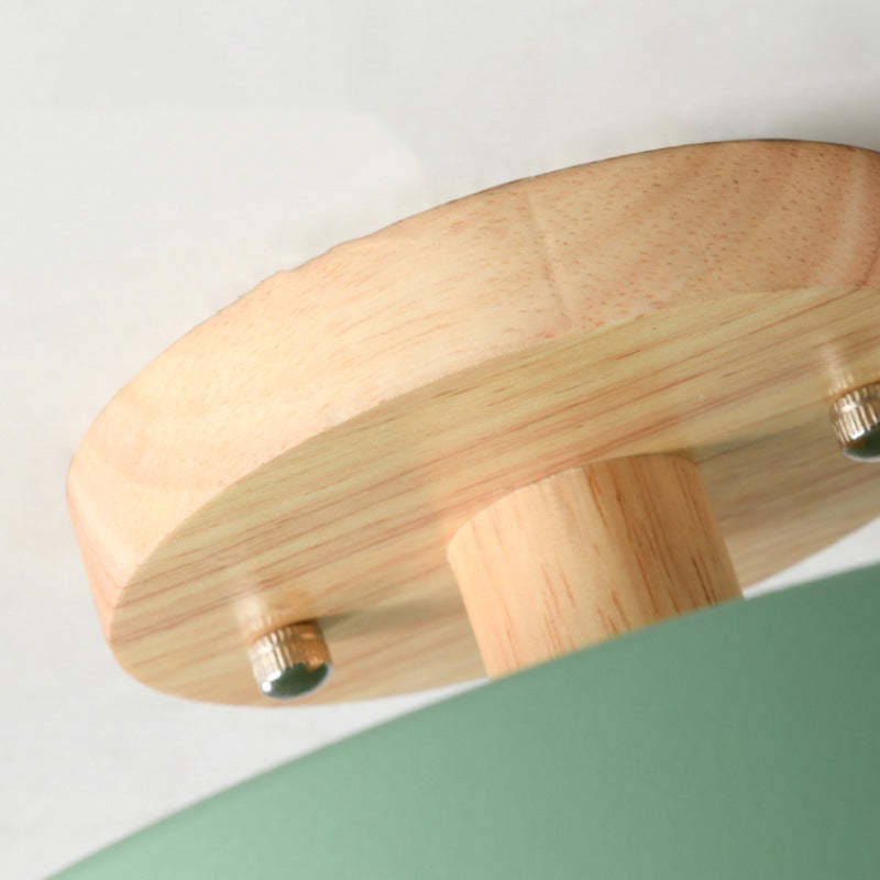 Wood flush mount ceiling lamp close-up showing wood ring and metal fasteners