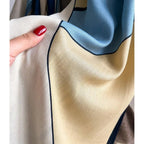 Beige oversized scarf with textured weave and navy edge trim