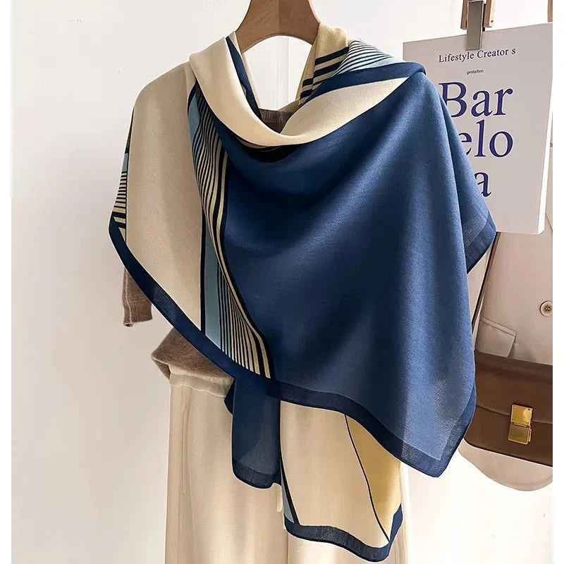 Oversized winter scarf in blue and cream with black striped geometric border
