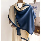 Oversized winter scarf in blue and cream with black striped geometric border