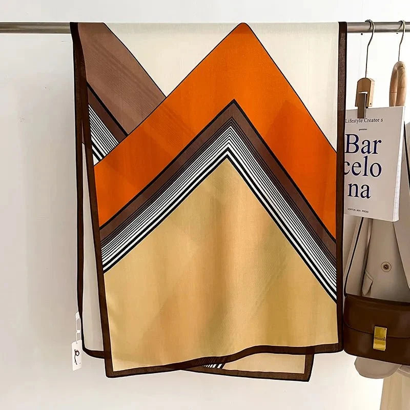 Oversized scarf in orange and tan with black striped chevron V design