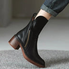 Women’s black leather ankle booties with side zipper, tassel pulls, and chunky block heel.