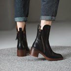 Women’s black ankle booties with side zipper and tassel pulls, showing chunky block heel.