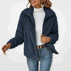 Dark blue textured zip-front women’s jacket with stand collar and long sleeves