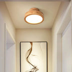 Round solid-wood flush mount LED ceiling lamp centered on the ceiling