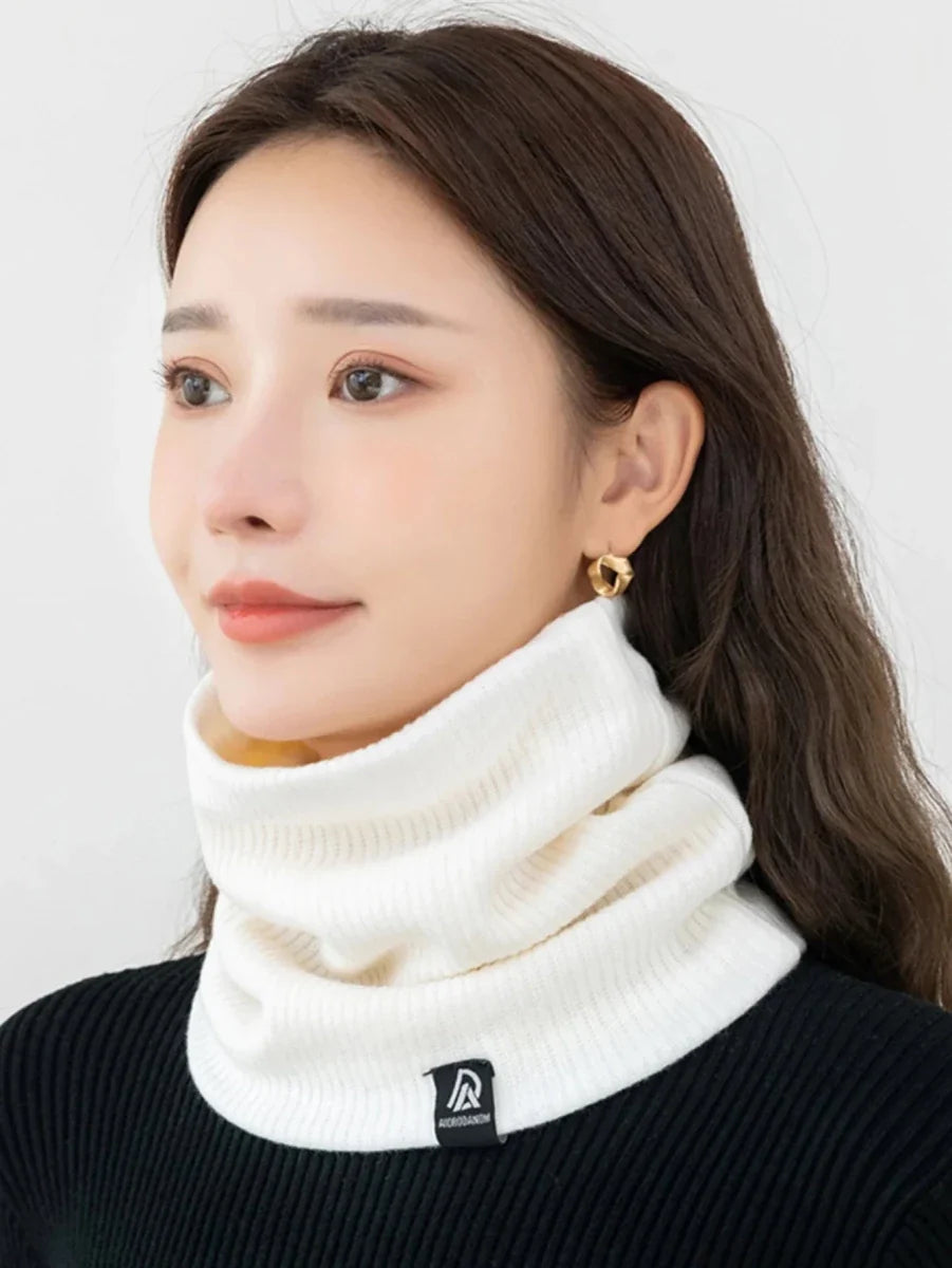 White knit neck warmer scarf with plush lining worn close around the neck
