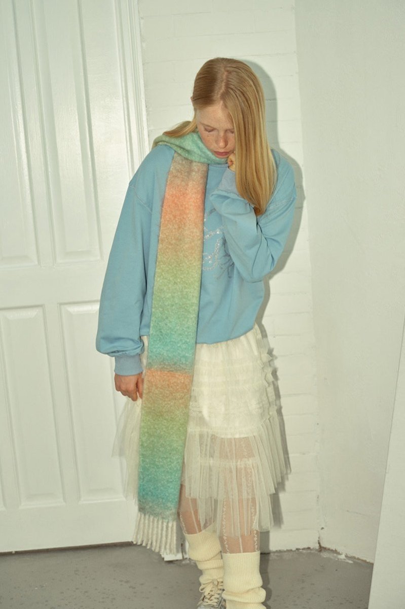 Pastel gradient knit scarf with peach, pink, and green bands and fringed ends