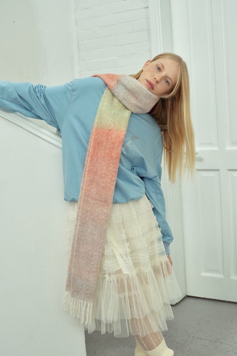 Long knit gradient scarf in coral, mint, and pale tones with fringed ends