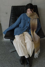 Blue to tan gradient knit scarf with long fringed ends for a cozy wrap