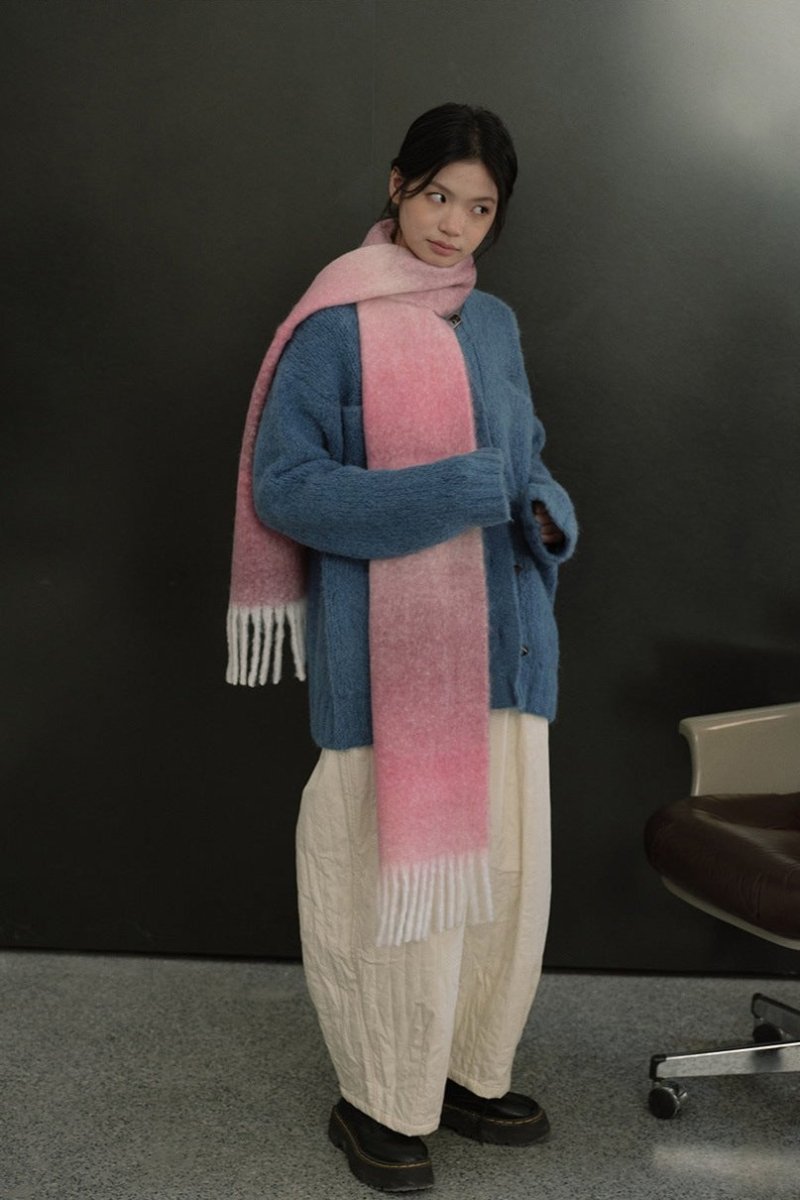 Long knit gradient scarf with pink center, blue sides, and fringed ends