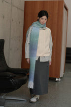Blue gradient knit scarf wrap with striped edging and long fringed ends