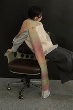 Long knit gradient scarf in pale green to blush pink with fringed ends