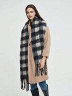 Black and white plaid cashmere scarf with long fringes, worn on the neck