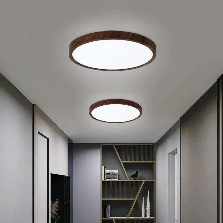Two round flush mount LED ceiling lights with dark wood rims