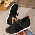 Women's lightweight slip-on sneakers, black knit with bow laces and white sole