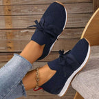 Women's lightweight slip-on sneakers, navy knit with lace-up bow and white outsole