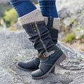 Women’s black winter boots with knit cuff, side zipper, and buckle strap