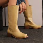Light brown knee-high boots with pull-on fit, stitched seam, and wooden block heel