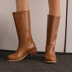 Brown knee-high riding boots with pull-on shaft and low stacked heel