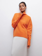 Orange knitted turtleneck sweater with ribbed collar, long sleeves, and hem