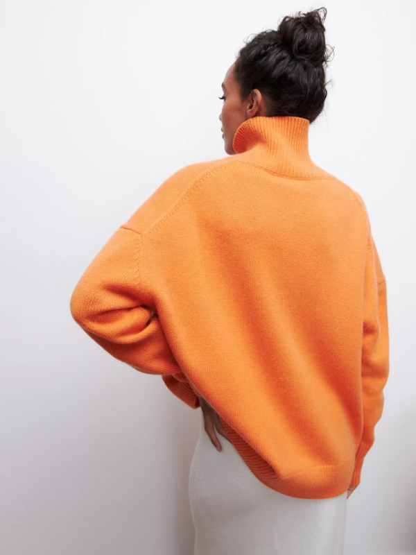 Orange knitted turtleneck sweater from the back, ribbed collar and cuffs