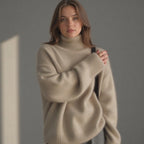 Women’s oversize cashmere turtleneck sweater in beige, relaxed fit and ribbed knit trim.