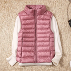 Rose-pink quilted bodywarmer vest with full-zip and stand collar over white sleeves