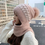 Blush pink knit beanie and infinity scarf set with swirl ribbing and faux-fur pom-pom