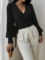 Women’s wrap sweater (black) with tie belt and V-neck; long sleeves with ribbed cuffs