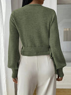 Women’s wrap sweater (green) with tie belt; long sleeves and ribbed cuffs