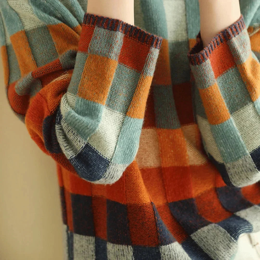 Multicolored patchwork turtleneck sweater sleeve and cuff detail, plaid knit pattern