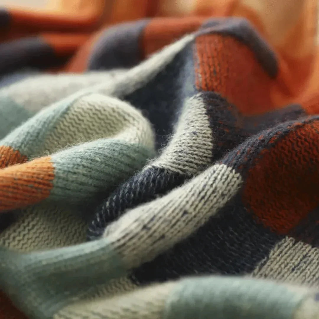 Patchwork turtleneck sweater fabric close-up showing multicolor plaid knit texture