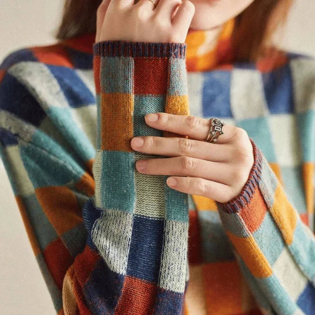 Women’s multicolored patchwork turtleneck sweater with striped plaid knit cuffs