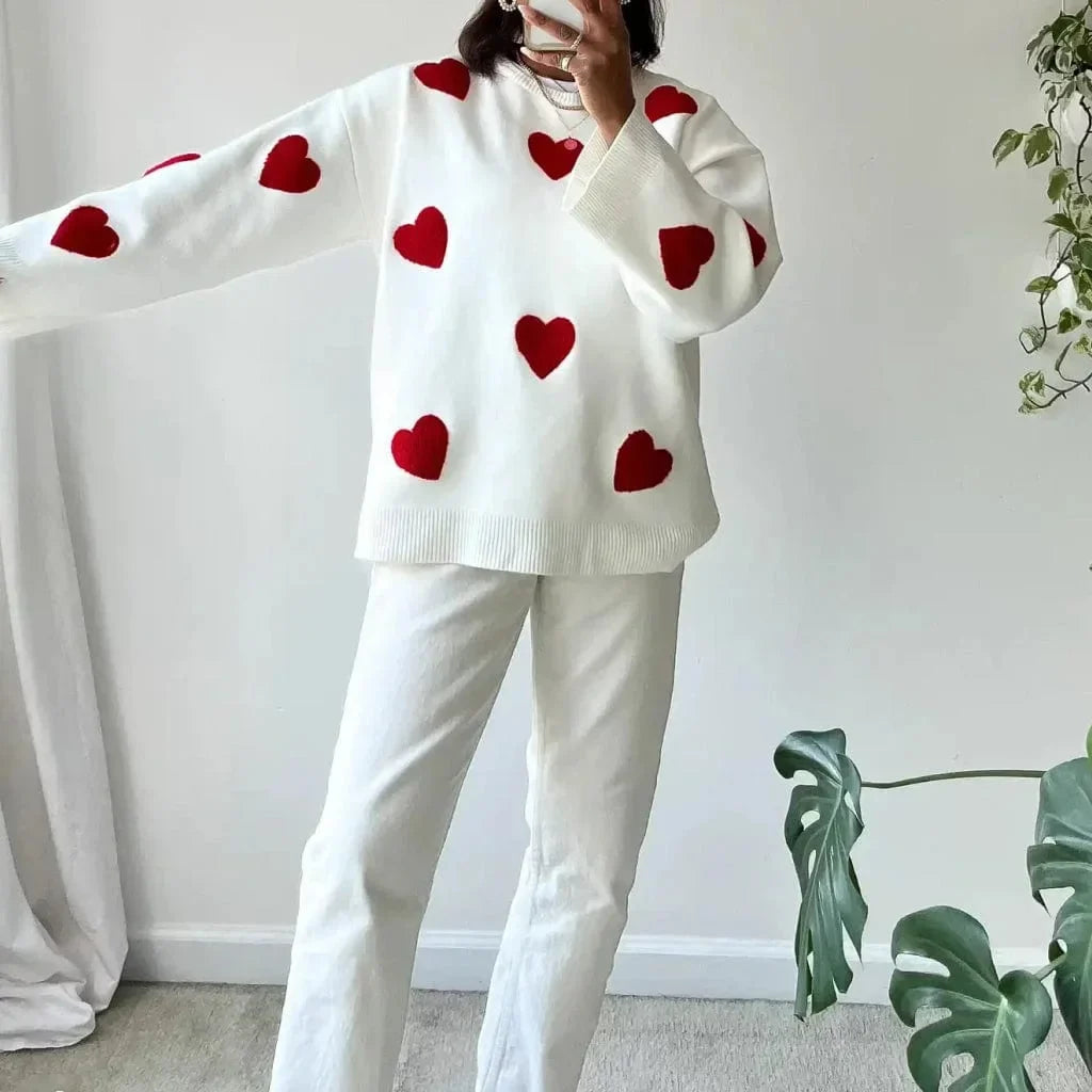 White sweater with red heart pattern, crewneck and long sleeves