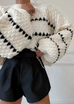 Textured knit sweater, cream with black diamond-and-stripe pattern, chunky cuffs