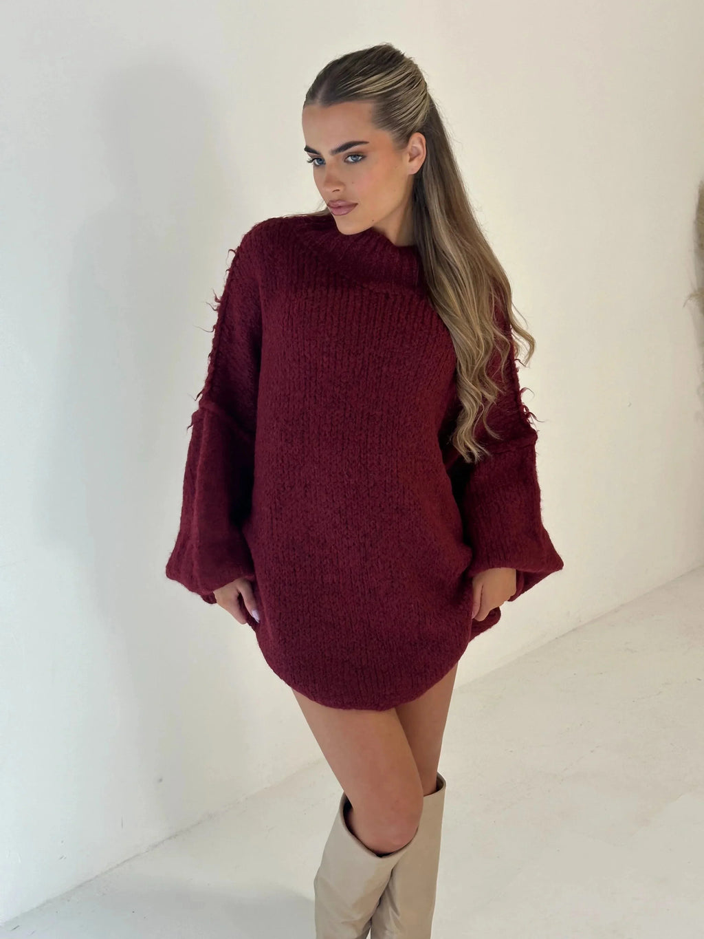 Burgundy loose knit turtleneck sweater with wide sleeves and soft texture