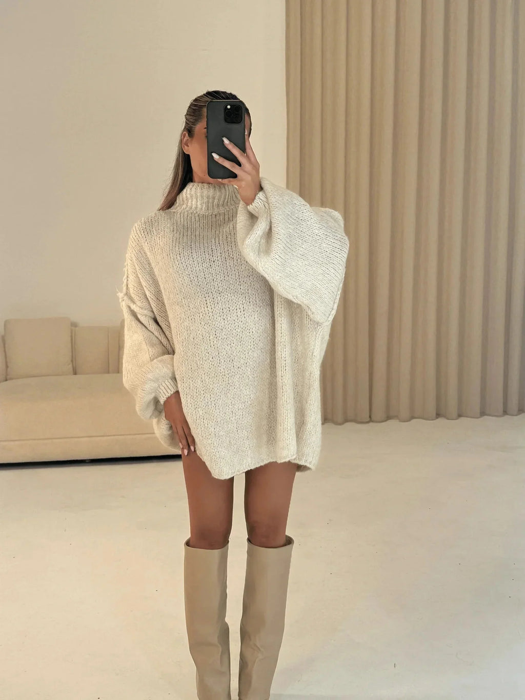 Vanilla loose turtleneck sweater with extended sleeves and relaxed back view