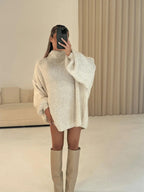 Vanilla loose turtleneck sweater with extended sleeves and relaxed back view