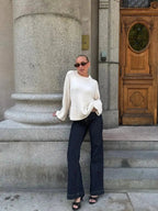 Women’s loose knit sweater, long sleeves, white; round neck and ribbed knit cuffs