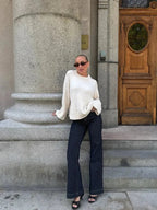Women’s loose knit sweater, long sleeves, white; round neckline and ribbed cuffs