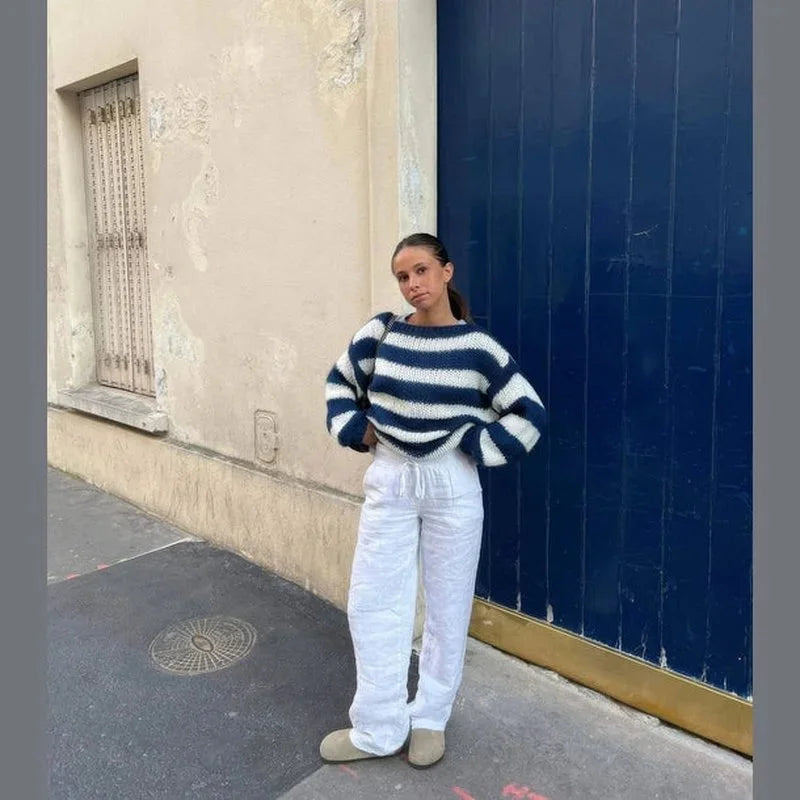 Navy and white striped knit sweater with dropped shoulders and long sleeves